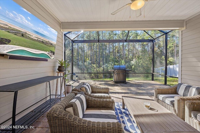 sunroom with a wealth of natural light and ceiling fan