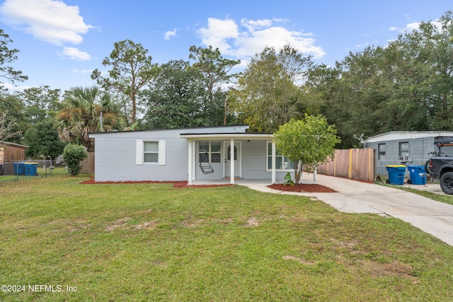 view of front of house with a porch and a front yard