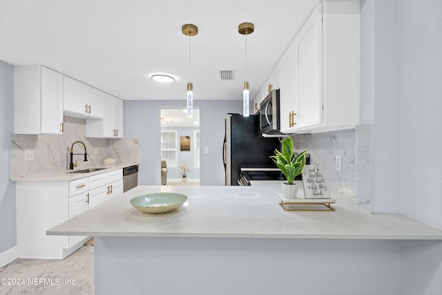 kitchen with kitchen peninsula, stainless steel appliances, sink, decorative light fixtures, and white cabinets