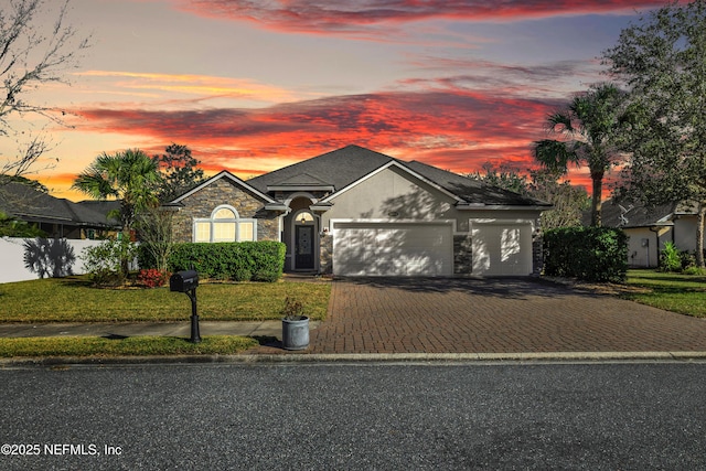 view of front facade with a garage and a yard