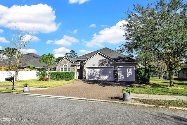 view of front of house featuring a front yard and a garage