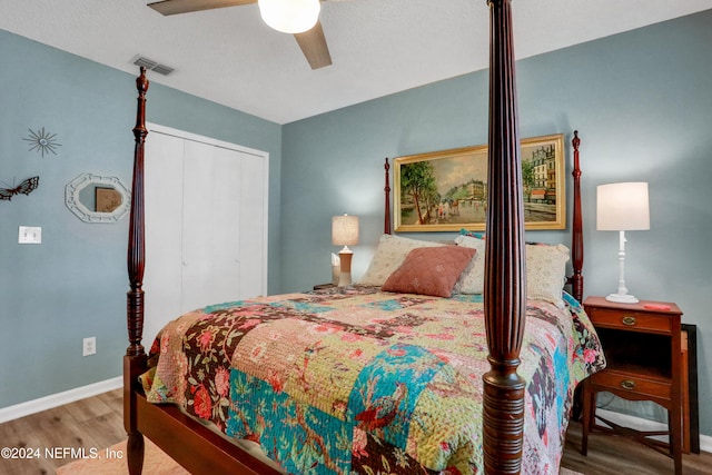 bedroom featuring ceiling fan, a closet, and wood-type flooring