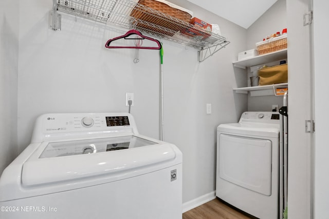 washroom with washer and dryer and hardwood / wood-style flooring