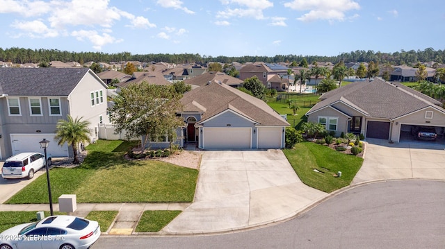 view of front of house with a residential view, an attached garage, concrete driveway, and a front lawn