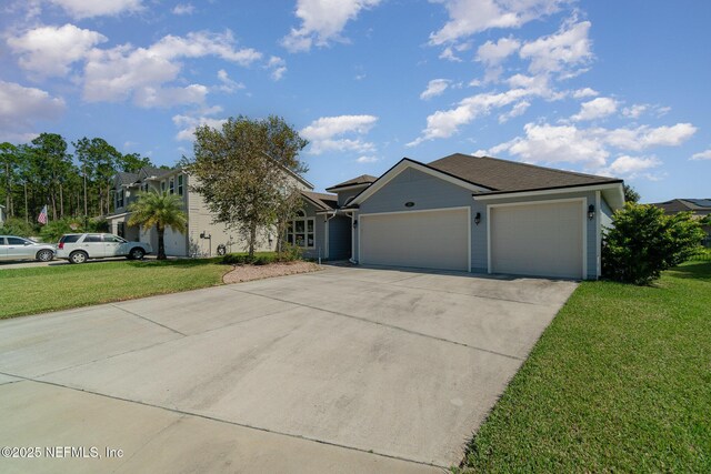 ranch-style house featuring a front lawn, concrete driveway, and an attached garage