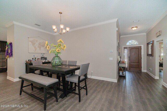 dining space with a chandelier, visible vents, baseboards, and wood finished floors