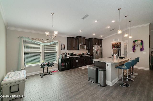 kitchen featuring ornamental molding, dark wood-style floors, visible vents, and stainless steel appliances