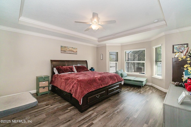 bedroom featuring a tray ceiling, dark wood-style floors, and baseboards