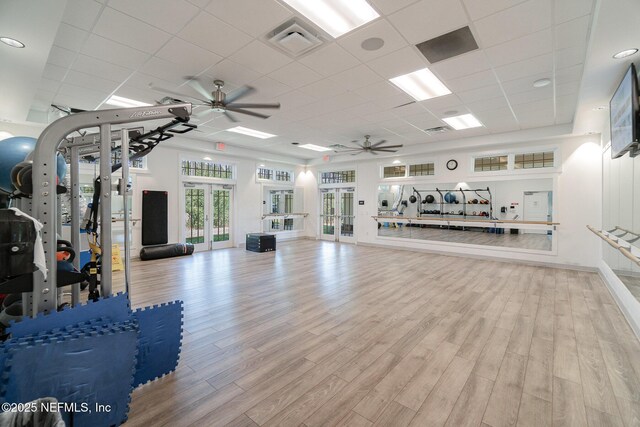 interior space with visible vents, french doors, ceiling fan, and wood finished floors