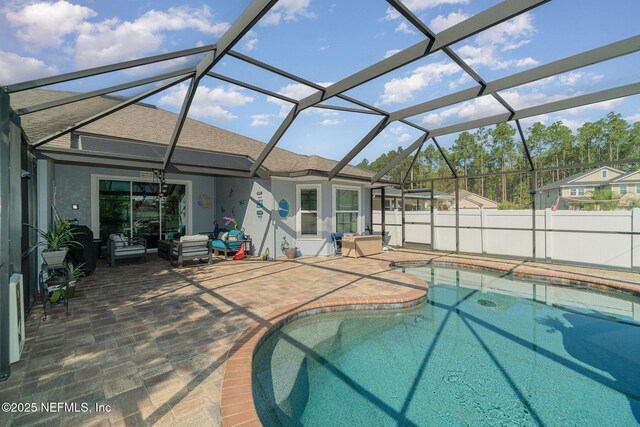 view of pool with a lanai, a fenced in pool, and a patio