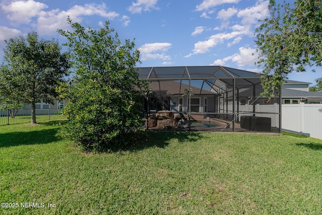 view of yard with a lanai, a swimming pool, and a fenced backyard