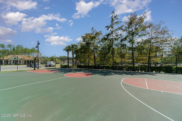 view of basketball court with community basketball court and fence