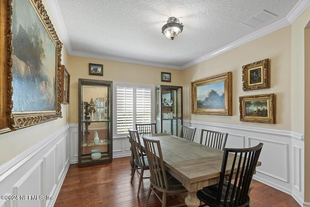 dining room featuring a textured ceiling, crown molding, and dark hardwood / wood-style floors