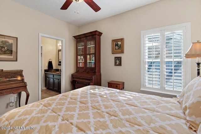 bedroom featuring ceiling fan and ensuite bath