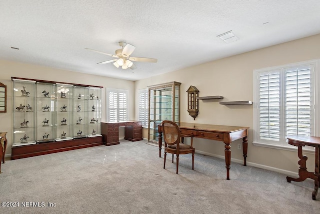 office area featuring light carpet and ceiling fan