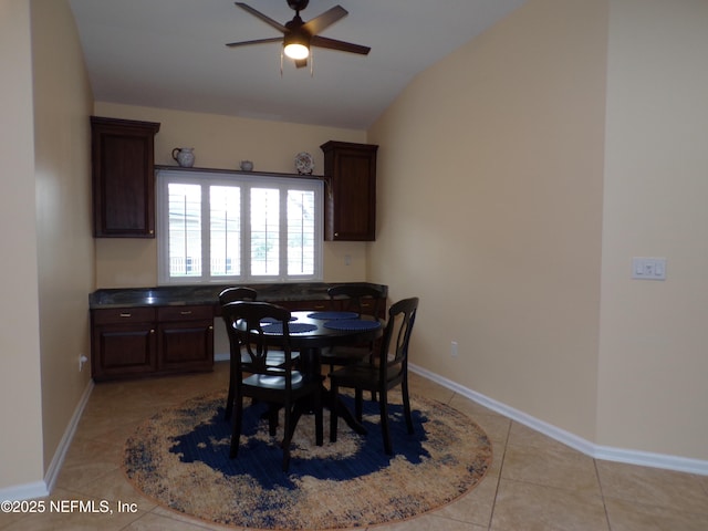 dining area with light tile patterned floors, ceiling fan, and lofted ceiling