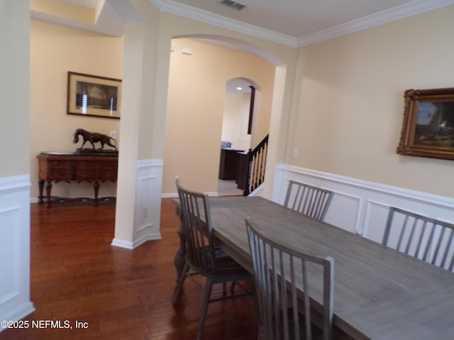 dining room with dark wood-type flooring and crown molding