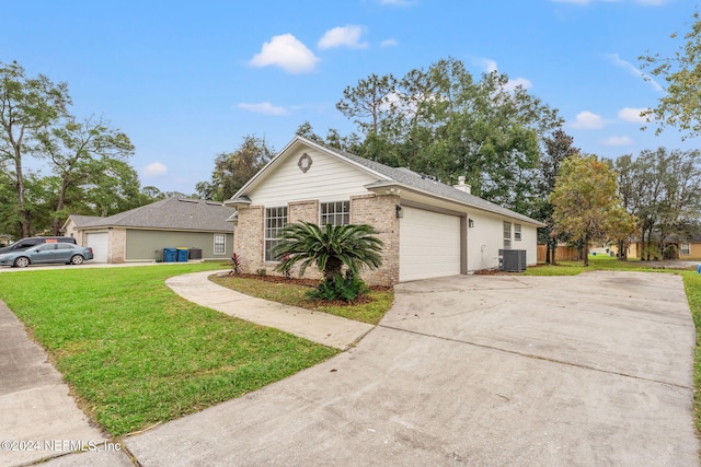 ranch-style home with a front yard, central AC, and a garage