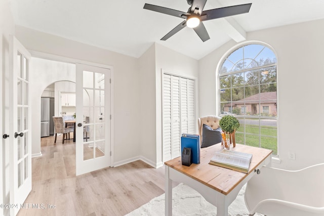 office space with vaulted ceiling with beams, ceiling fan, light wood-type flooring, and french doors