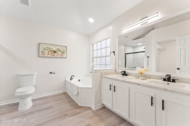 full bathroom featuring vanity, toilet, wood-type flooring, and plus walk in shower