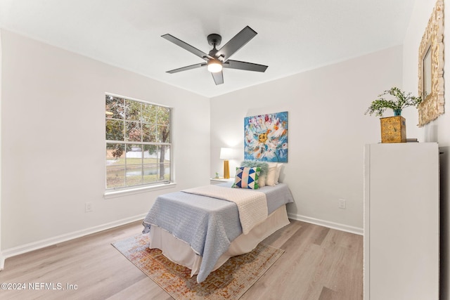 bedroom with ceiling fan and light wood-type flooring