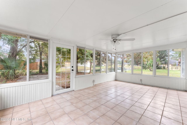 unfurnished sunroom featuring a wealth of natural light and ceiling fan