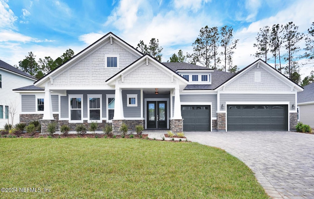 craftsman inspired home featuring french doors and a front lawn