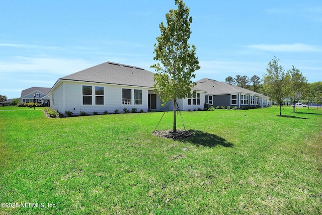 rear view of house with a yard