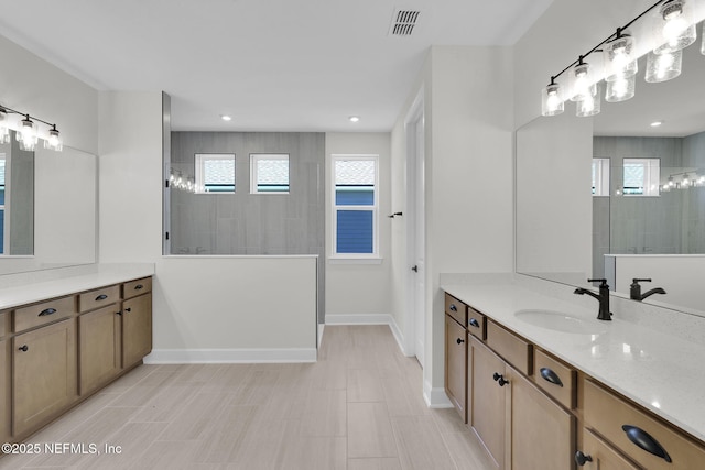 full bathroom featuring baseboards, a walk in shower, vanity, and recessed lighting
