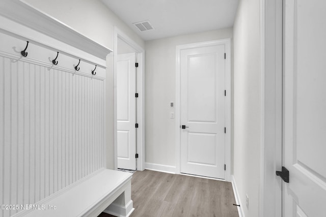 mudroom featuring light wood-style floors and baseboards