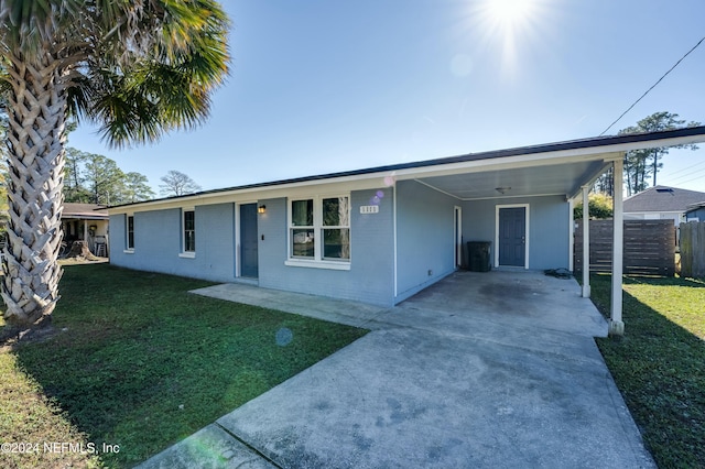 view of front facade with a front lawn and a carport