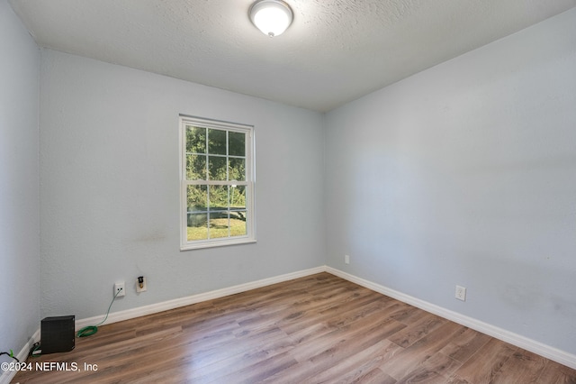 spare room with wood-type flooring