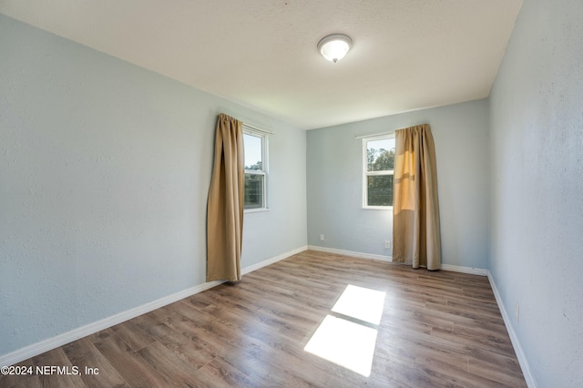 empty room with light hardwood / wood-style floors