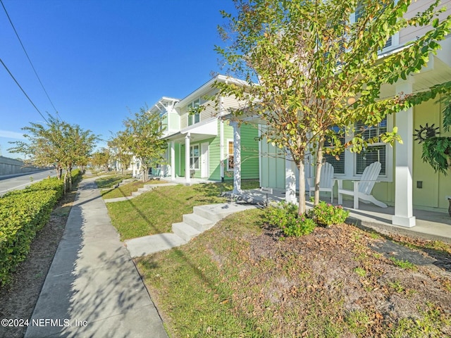 view of front of home with covered porch and a front yard