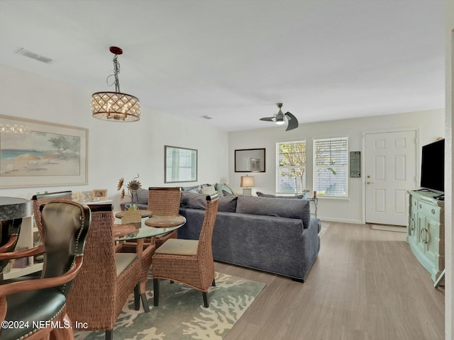 dining space with light hardwood / wood-style floors and ceiling fan