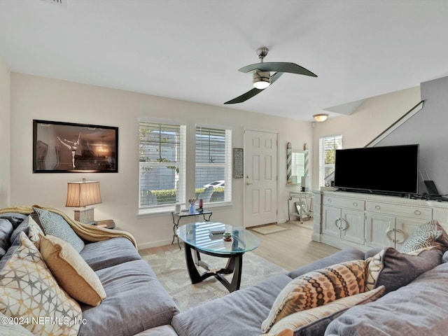 living room featuring light wood-type flooring and ceiling fan