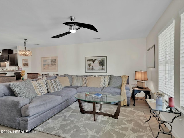 living room featuring light hardwood / wood-style floors and ceiling fan