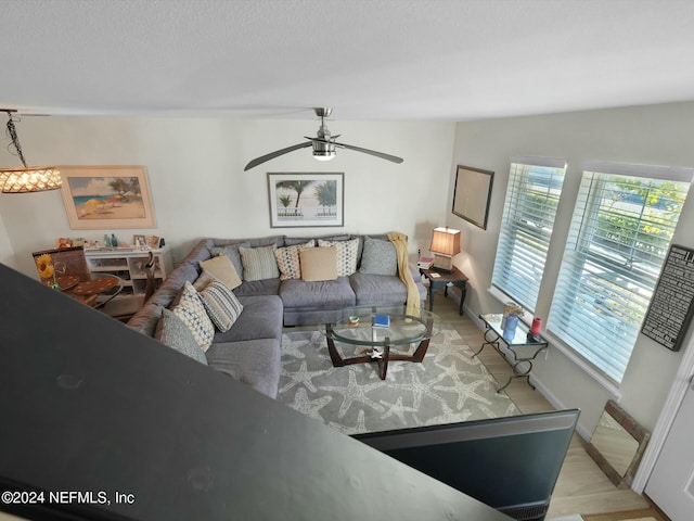 living room featuring light hardwood / wood-style flooring and ceiling fan