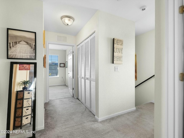 hallway with light carpet