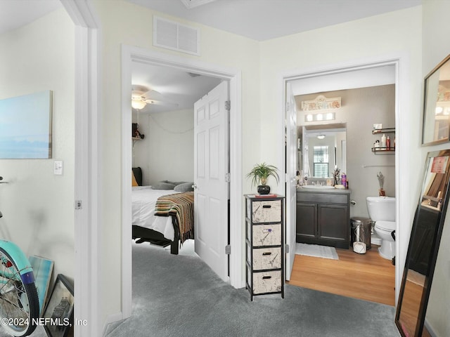 interior space featuring vanity, toilet, and ceiling fan