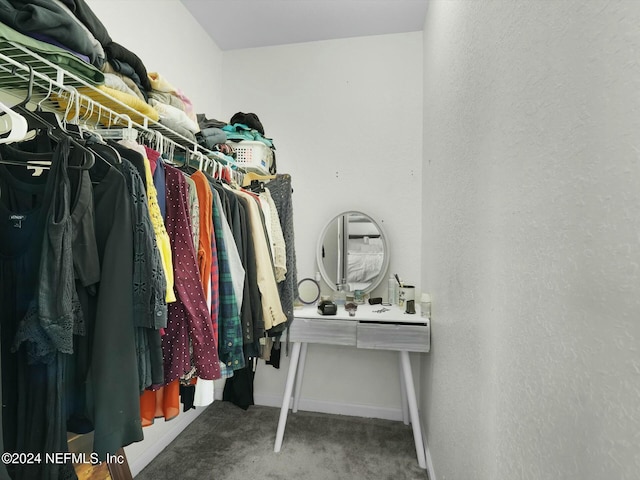 walk in closet with carpet