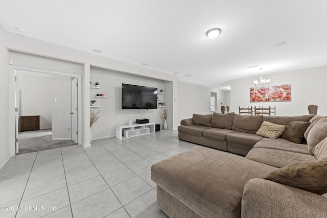 living room featuring a notable chandelier and light tile patterned flooring