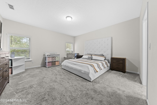 carpeted bedroom featuring a textured ceiling