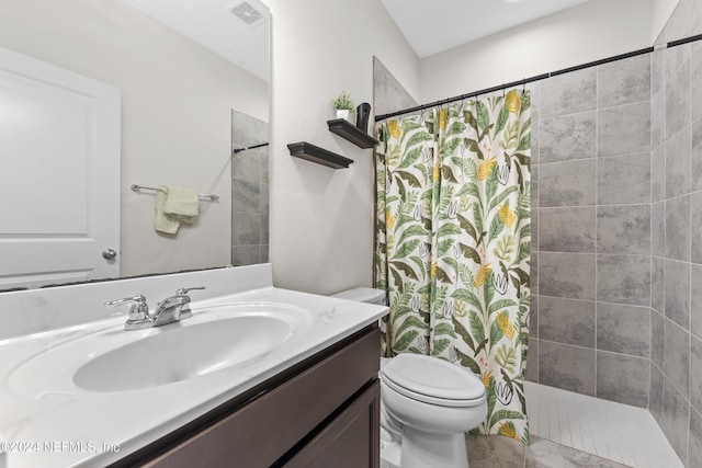 bathroom with a shower with shower curtain, vanity, and toilet