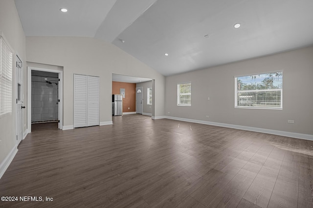 unfurnished living room with vaulted ceiling and dark hardwood / wood-style floors