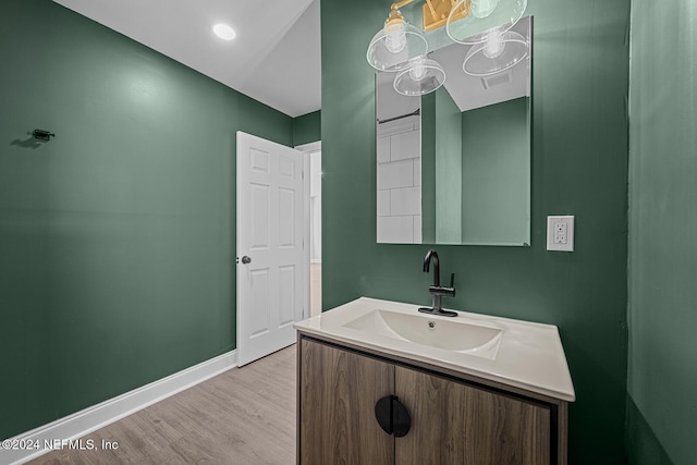 bathroom with hardwood / wood-style floors and vanity