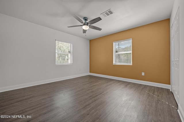 unfurnished room featuring ceiling fan and dark wood-type flooring