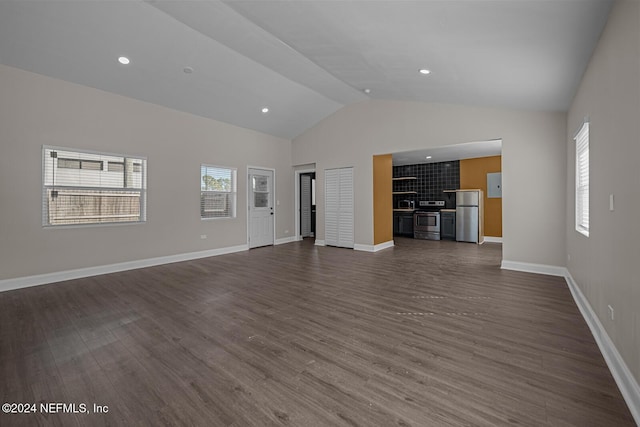 unfurnished living room featuring a healthy amount of sunlight, lofted ceiling, and dark wood-type flooring