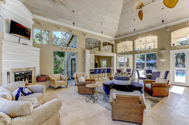 sunroom / solarium featuring a tile fireplace and wooden ceiling