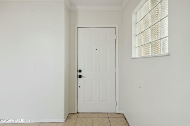 doorway featuring light tile patterned flooring and ornamental molding